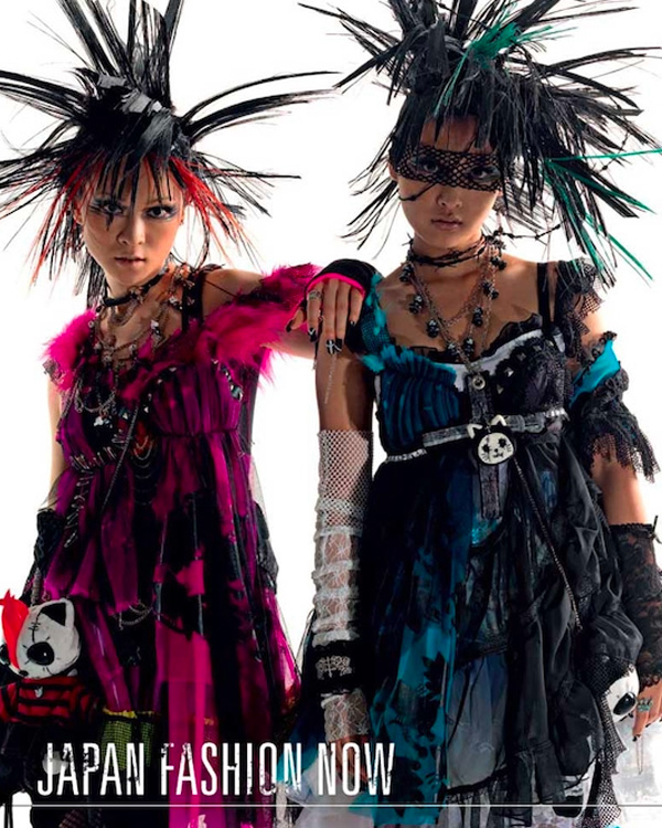 two girls, dressed in pink and blue respectively, with extravagant, spiky hairdos
