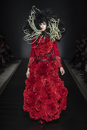 runway image of model in red dress of roses