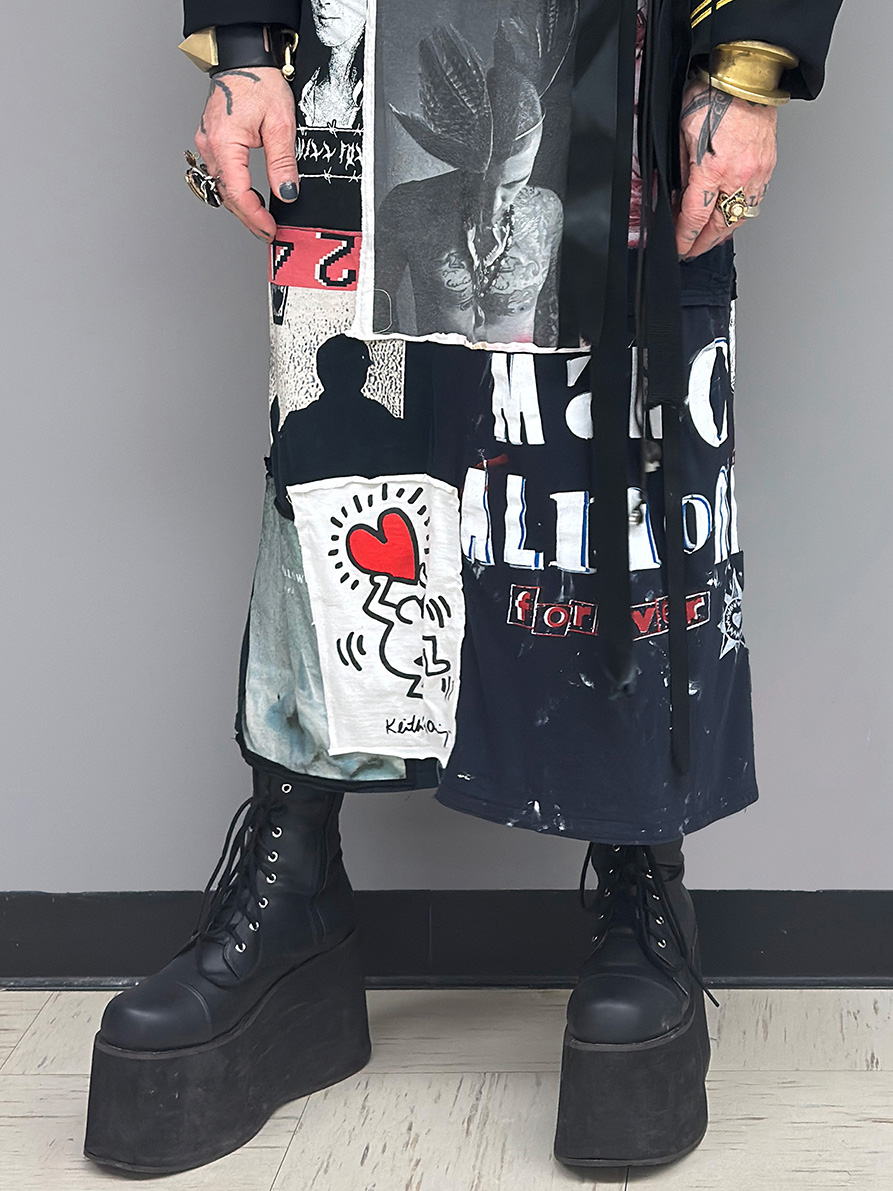 black platform lace up boots and the skirt of an ankle length dress comprised of various t-shirts 