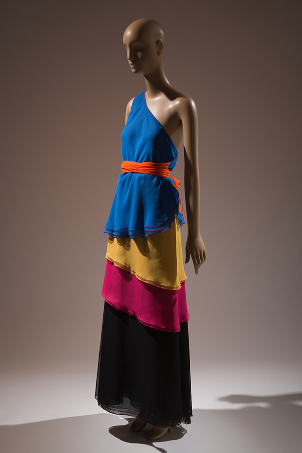 Floor-length evening dress on a mannequin in color block, layered chiffon tiers.