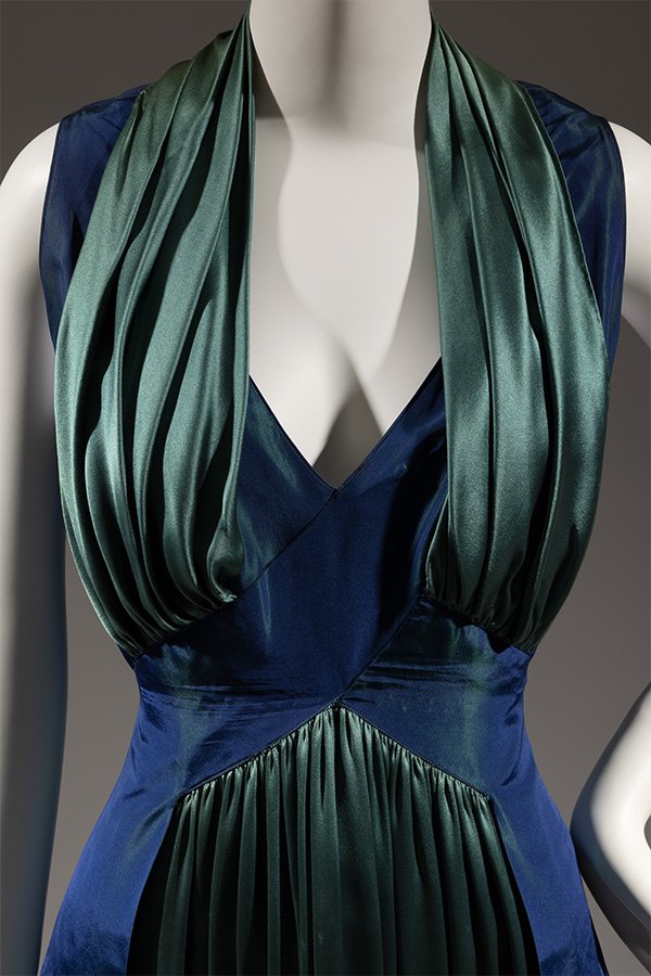 Bodice view of blue and green evening dress wih blue cross-over bodice creating a deep V-neck