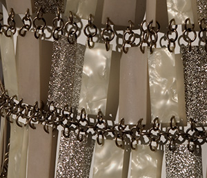 close up of shimmering beige and gold plastic rectangles chained together