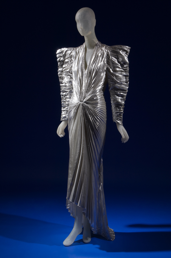 long evening dress in pleated silver metallic lam with futuristic angular styling wide padded shoulders