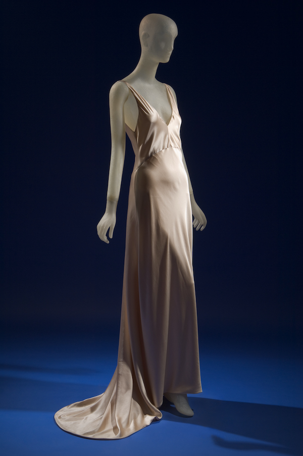 mannequin wearing cream silk floor length sleeveless gown