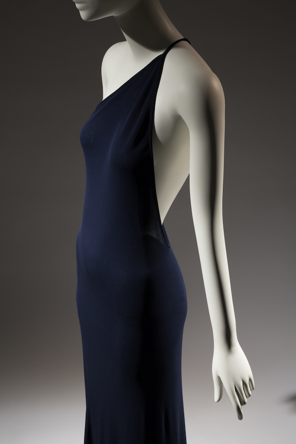 mannequin wearing a one shoulder navy silk dress