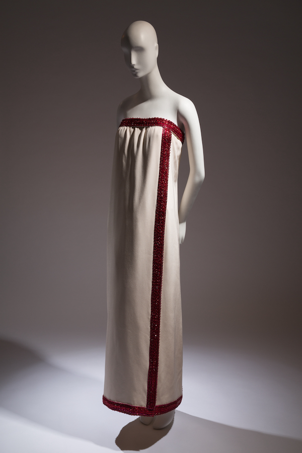 mannequin wearing strapless cream and red evening gown 