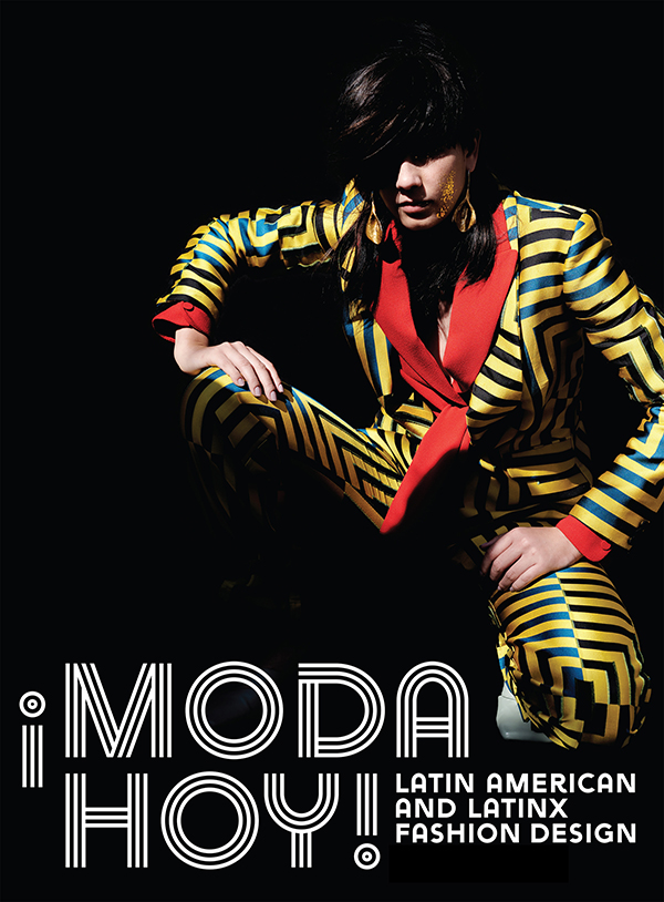 masculine model wearing a yellow suit with green stripes and red accents