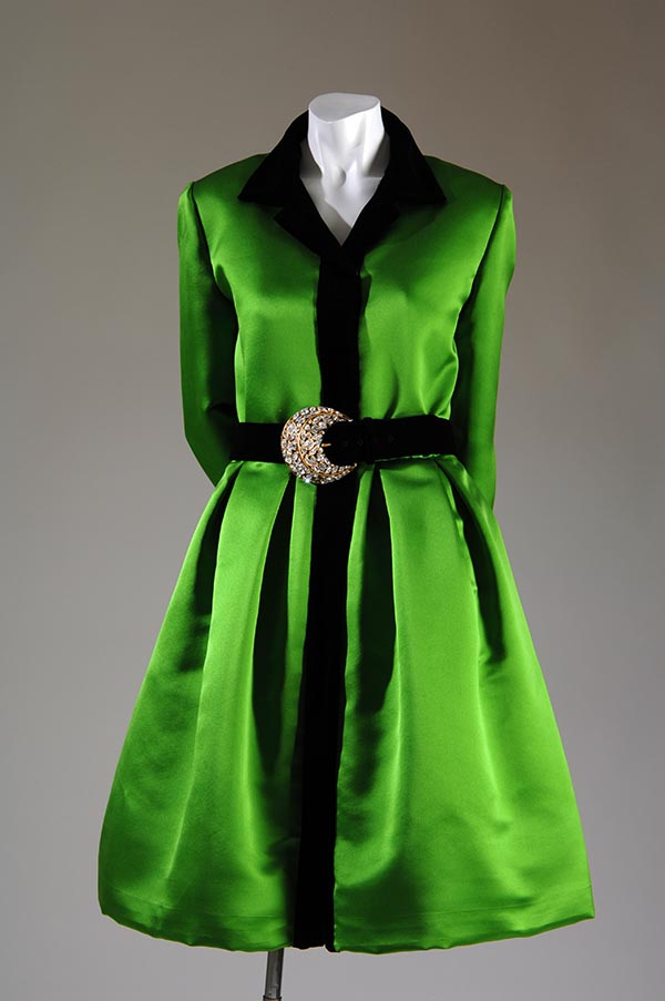 green ensemble with black collar, belt, and trim