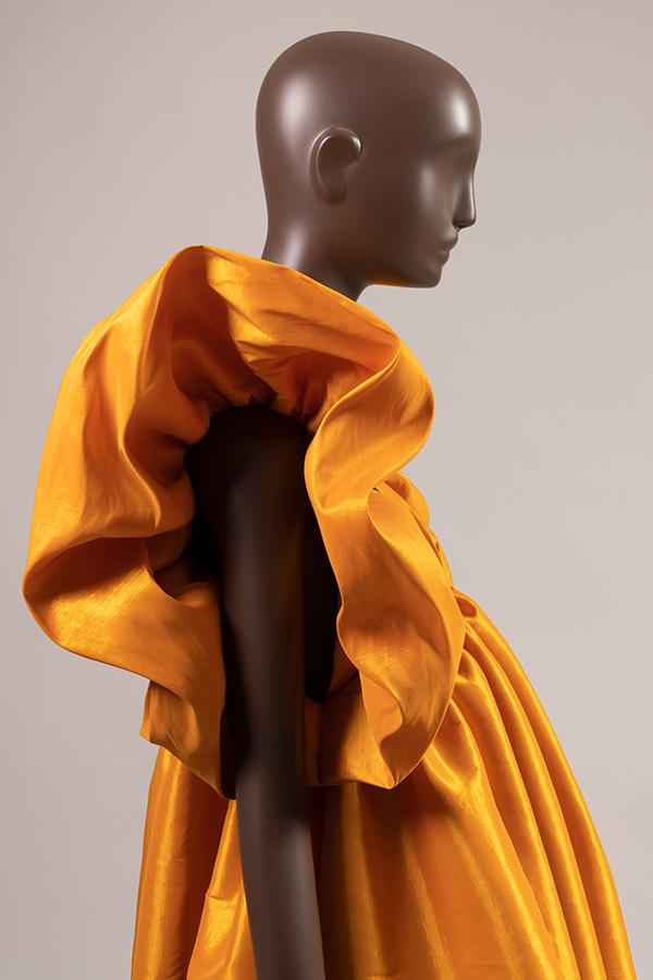 side profile of a golden yellow dress with ruffle sleeve