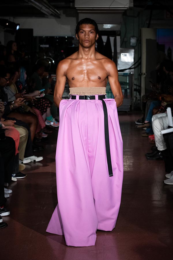model wearing pink wide legged high waisted pants