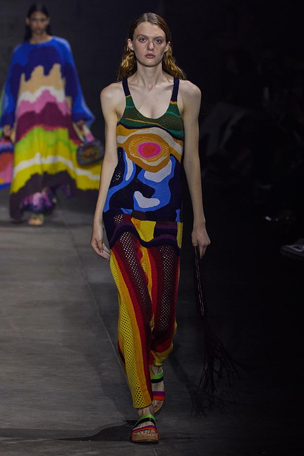 model on runway wearing a colorful long dress