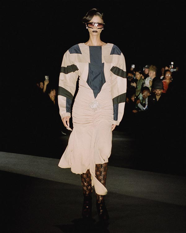 model wearing tan and navy long sleeve dress