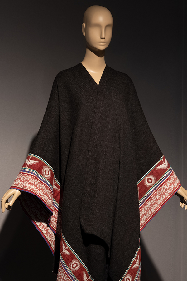 brown cape with a red and white patterned border