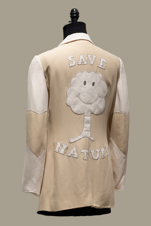 Back view of a beige and off white cotton long sleeve jacket with Save Nature smiling tree applique design center back and with heart shaped elbow patches 