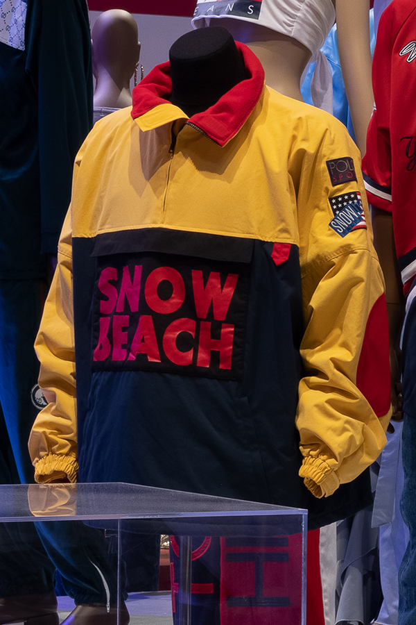 Yellow and blue pullowever jacket with "Snow Beach" on front in red block letters sweatshirt with D-NICE Club Quarantine lettering