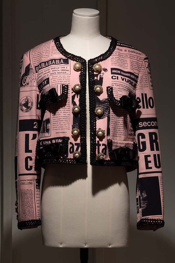 Pink and black Italian newspaper print Chanel style wool jacket on a dress form