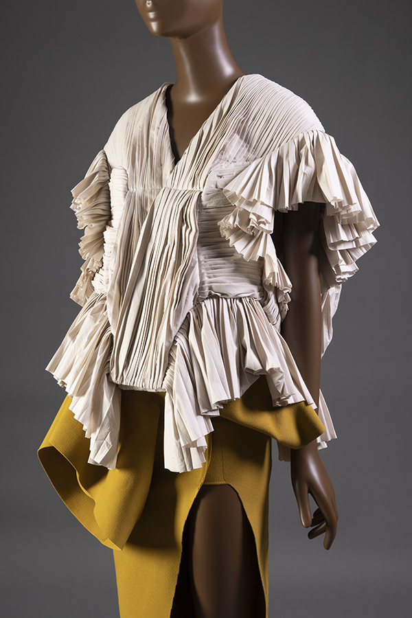 Yellow / brown floor length short sleeve raw edge dress a thigh high slit and coordinating off white knife pleated ruffled sleeve overblouse