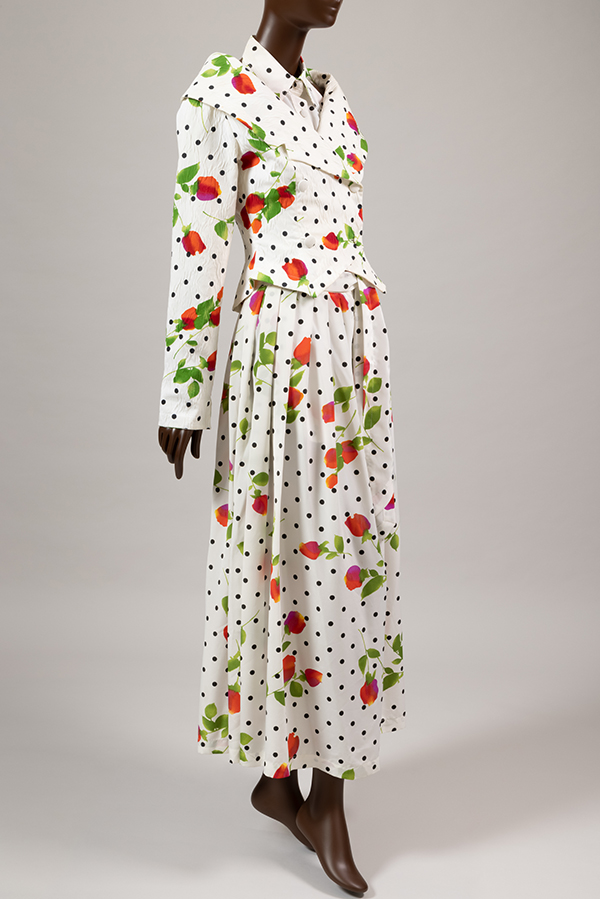 ensemble of double breasted jacket, sleeveless halter top, and wide leg pants in white cotton printed in rose and polka dot pattern 