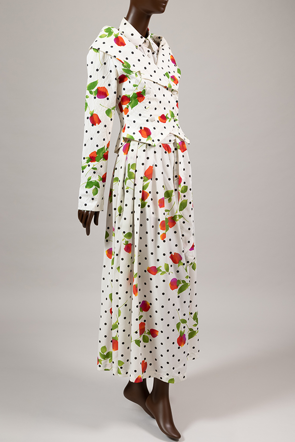 ensemble of double breasted jacket, sleeveless halter top, and wide leg pants in white cotton printed in rose and polka dot pattern