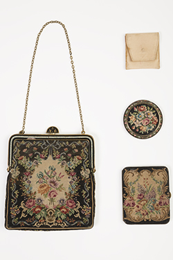 small bag with floral decorations alongside three small cases