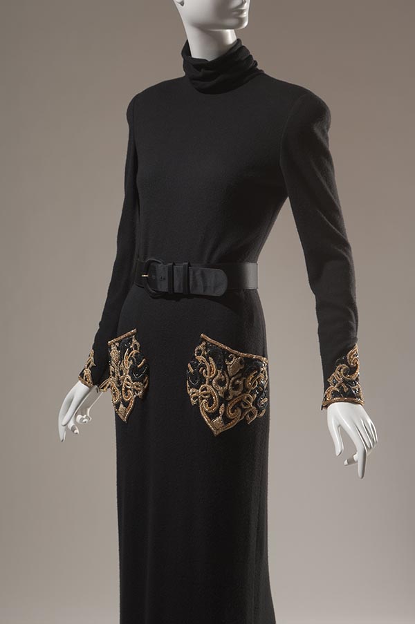 long sleeve black dress with gold embroidery on left and right side pockets