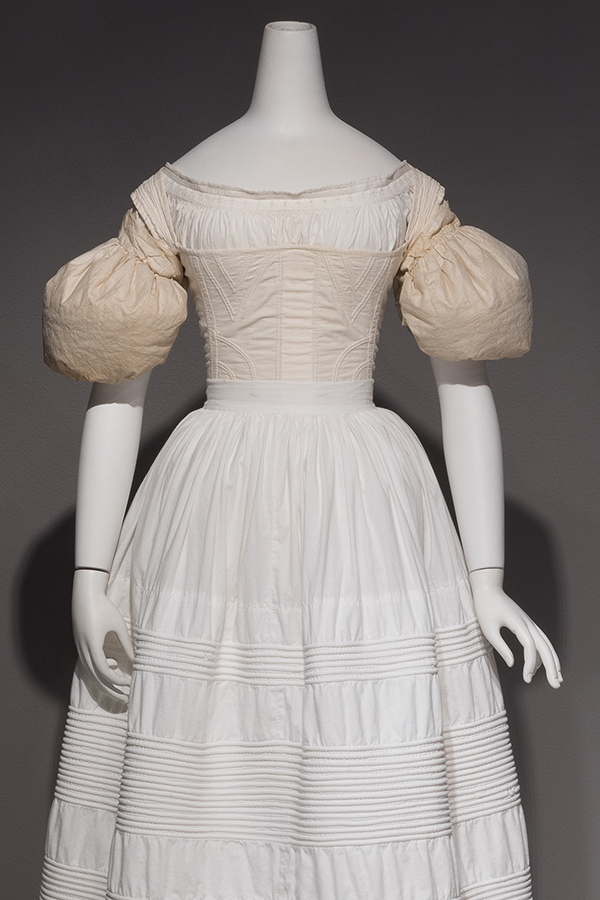 Pair of down-filled off white cotton sleeve puffs over a white chemise