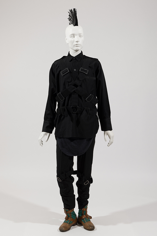 Man’s ensemble of a black long sleeve shirt with multiple straps across front and on matching pants