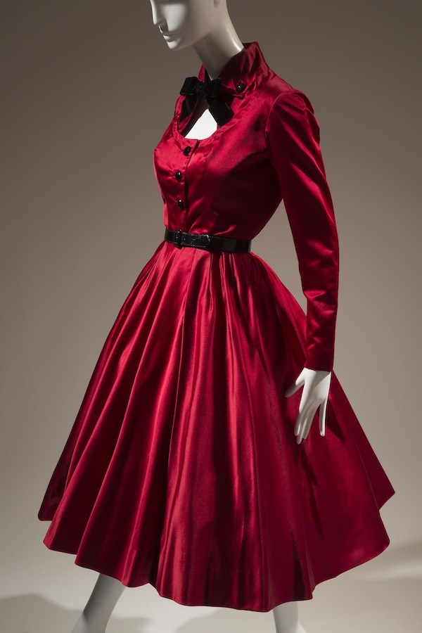 red long sleeve cocktail dress with coordinating black tie at neck