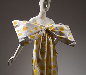 mannequin wearing ivory and yellow polka dot gown