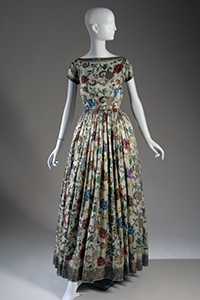 long dinner dress in richly embroidered light green silk with multicolor and gold metallic floral design