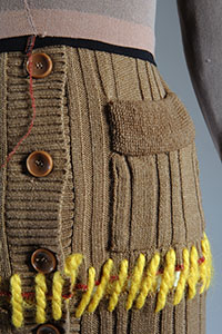 detail of 1994 XULY.Bet repurposed brown, yellow, and pink sweater with 3 large brown buttons and pocket