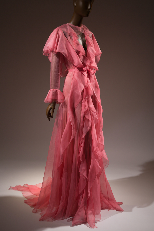 salmon pink robe-like dress in sheer fabric with flowing ruffles down center front