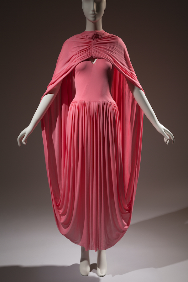 salmon pink jersey knit ankle length dress with attached cape and pleated skirt
