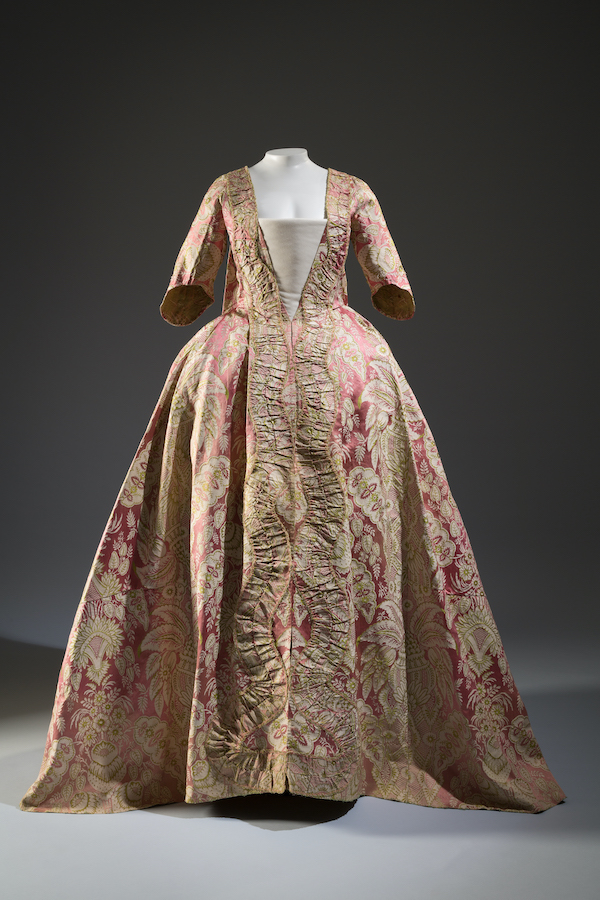 18th century robe a la francaise in printed pink silk fabric with beige foliage and floral motif with serpentine ruched fabric down center front
