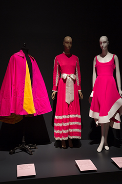 three mannequins dressed in pink ensembles on platform
