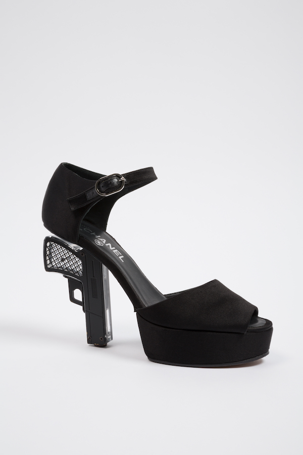 Black open-toe platform shoe with handgun heel pointed downward