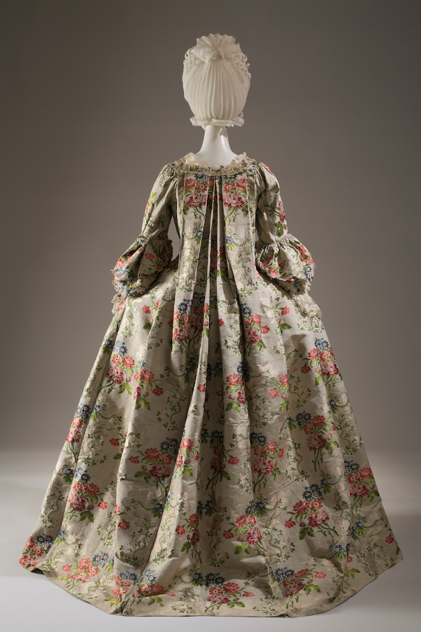 Robe  la franaise of brocaded silk with flower sprays in shades of red, peach, pink, blue, and green and leaves meander pattern on cannele ground