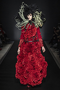 runway image of model in red dress of roses