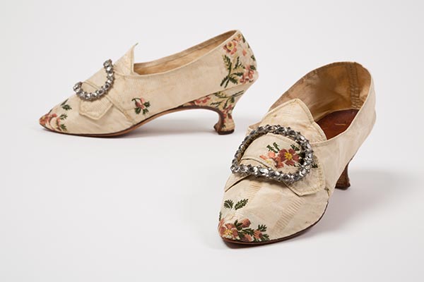 Ivory silk taffeta shoes with floral embroidery and large metal buckles with circular designs