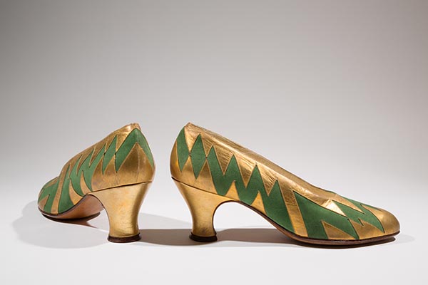 high heels in gold with green designs on the side