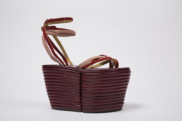 dark red leather high platform sandals with with thirteen leather layer sole divided at arch and red, yellow and pink suede thong strips with buckled ankle straps