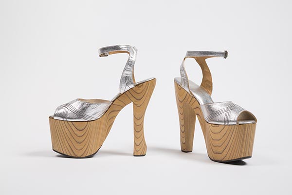Platform ankle strap shoes in silver leather, with top stitching forming diamond design at vamp, open round toe, high grained wooden platform sole with narrow, sculpted heel