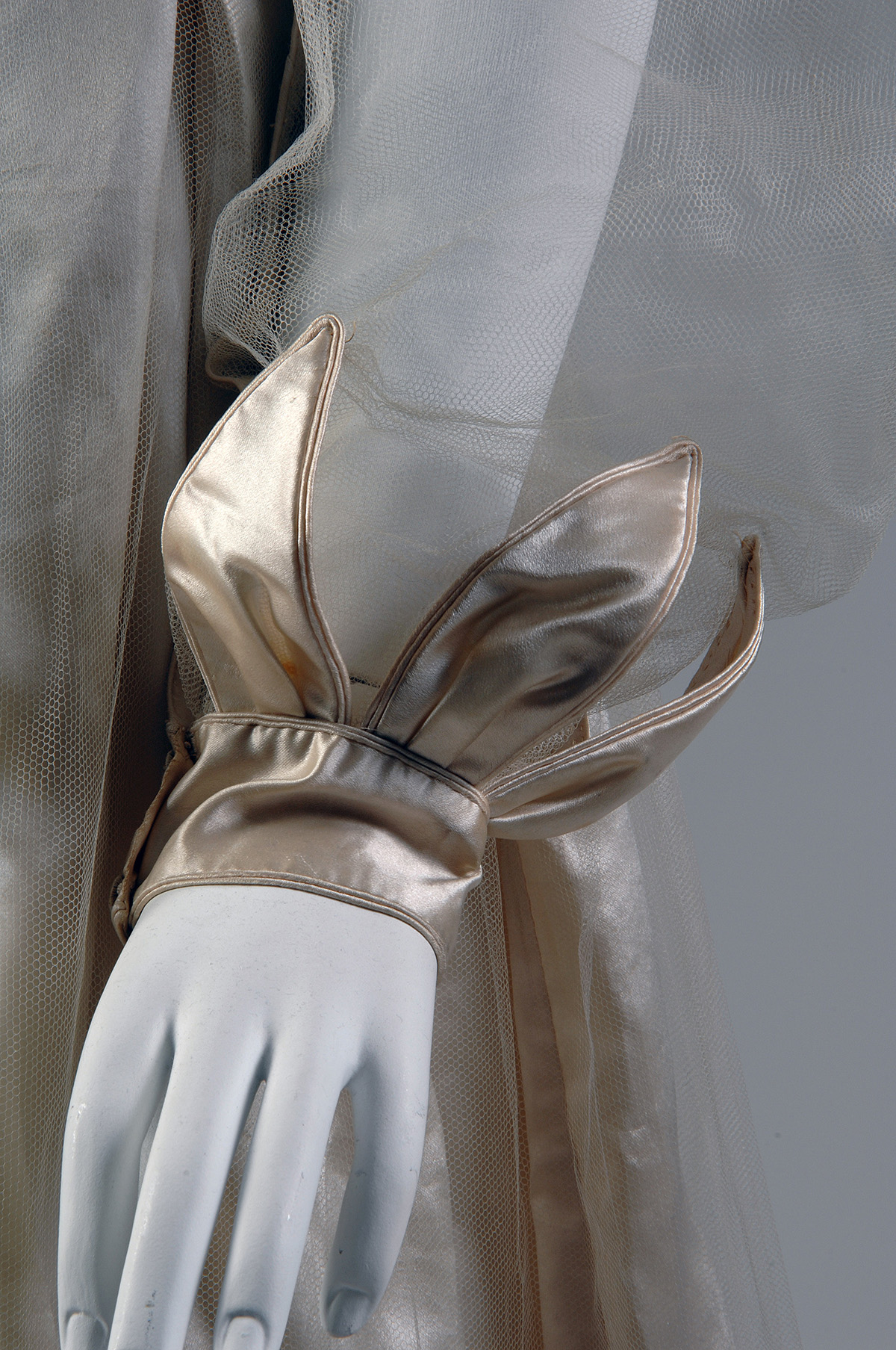 Close up of a long oversleeve crafted from sheer silk tulle.