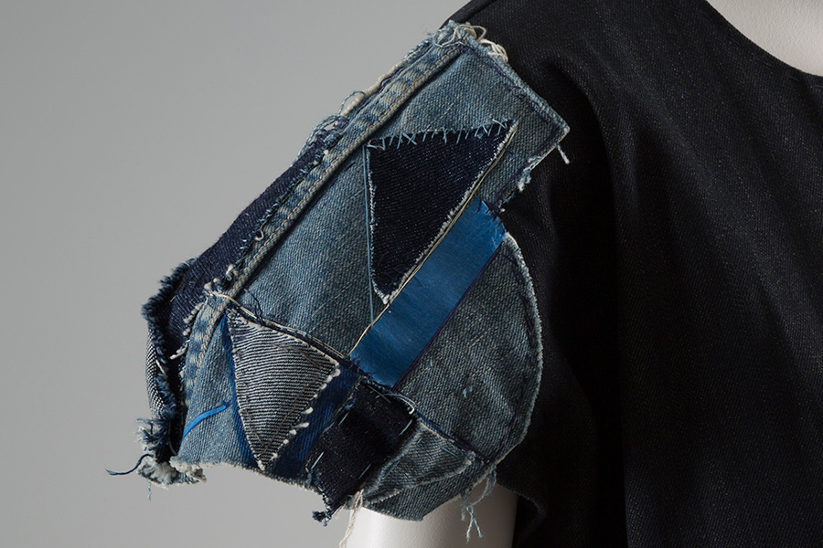 close up of denim patchwork sleeve of varying washes