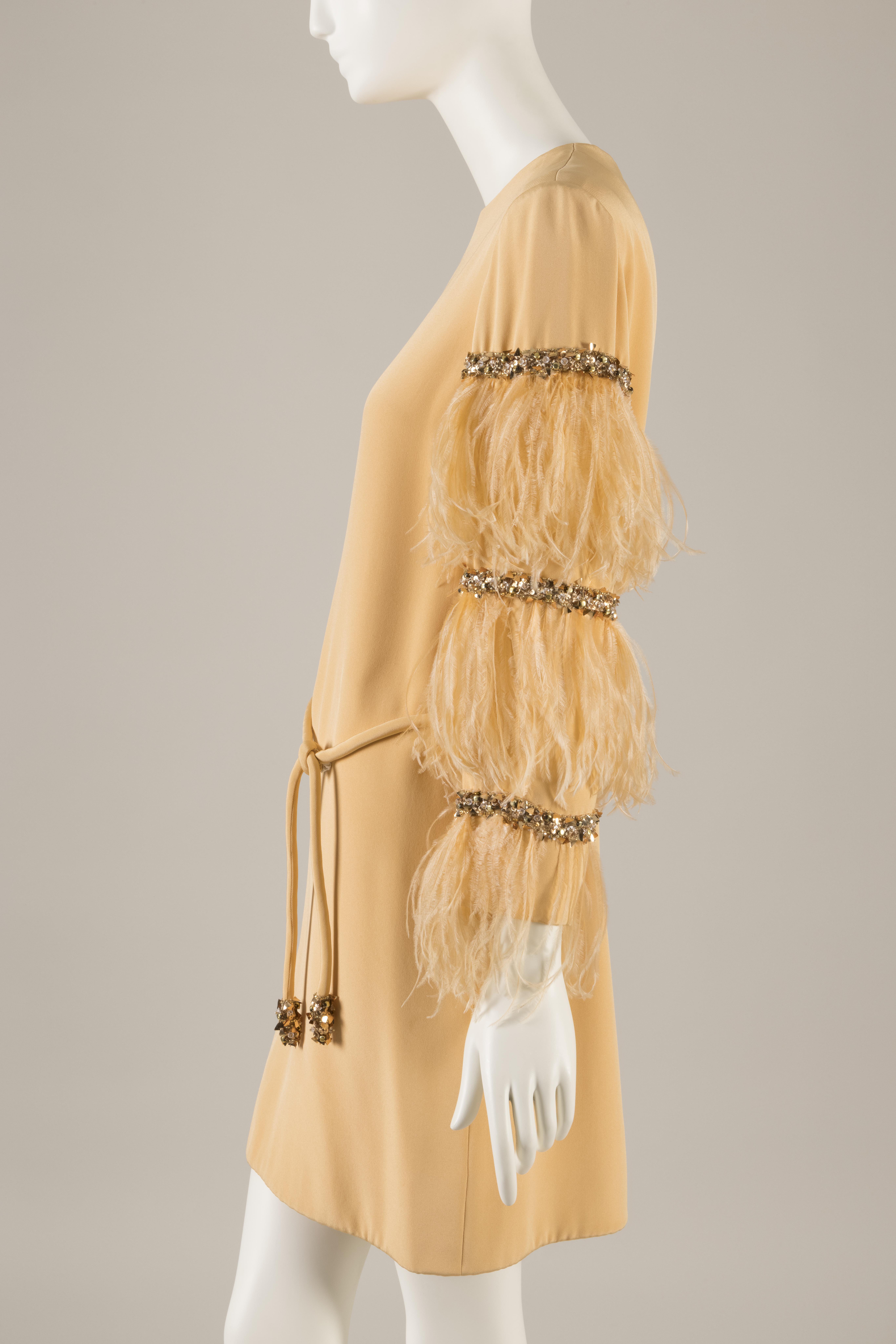 side view of a peach silk crepe dress with ostrich feather sleeves