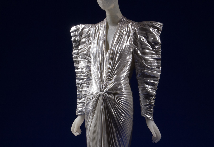 silver dress with angular shoulder pads and voluminous sleeves