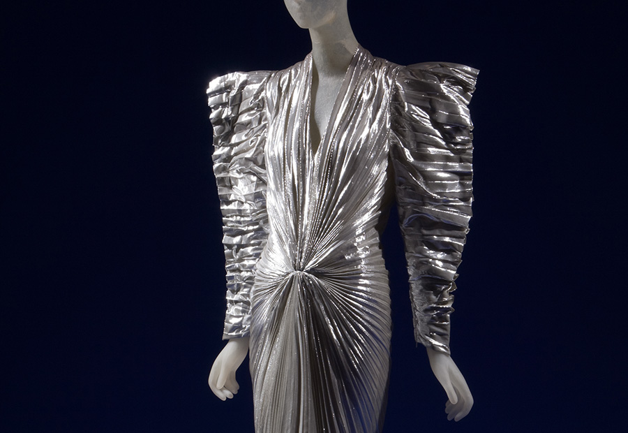 silver dress with angular shoulders and voluminous sleeves