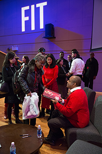 jeffrey banks and guest holding a copy of norell: dean of american fashion book