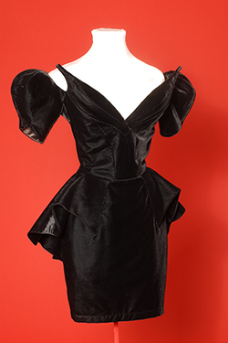 black low neckline dress with fang-like points projecting from the fabric 