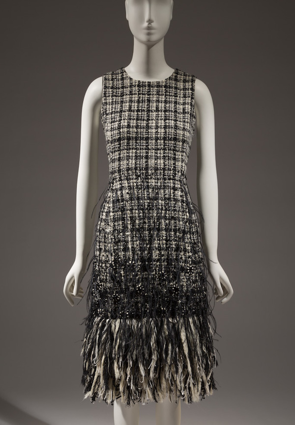 black and white sleeveless dress with black feathers at the bottom